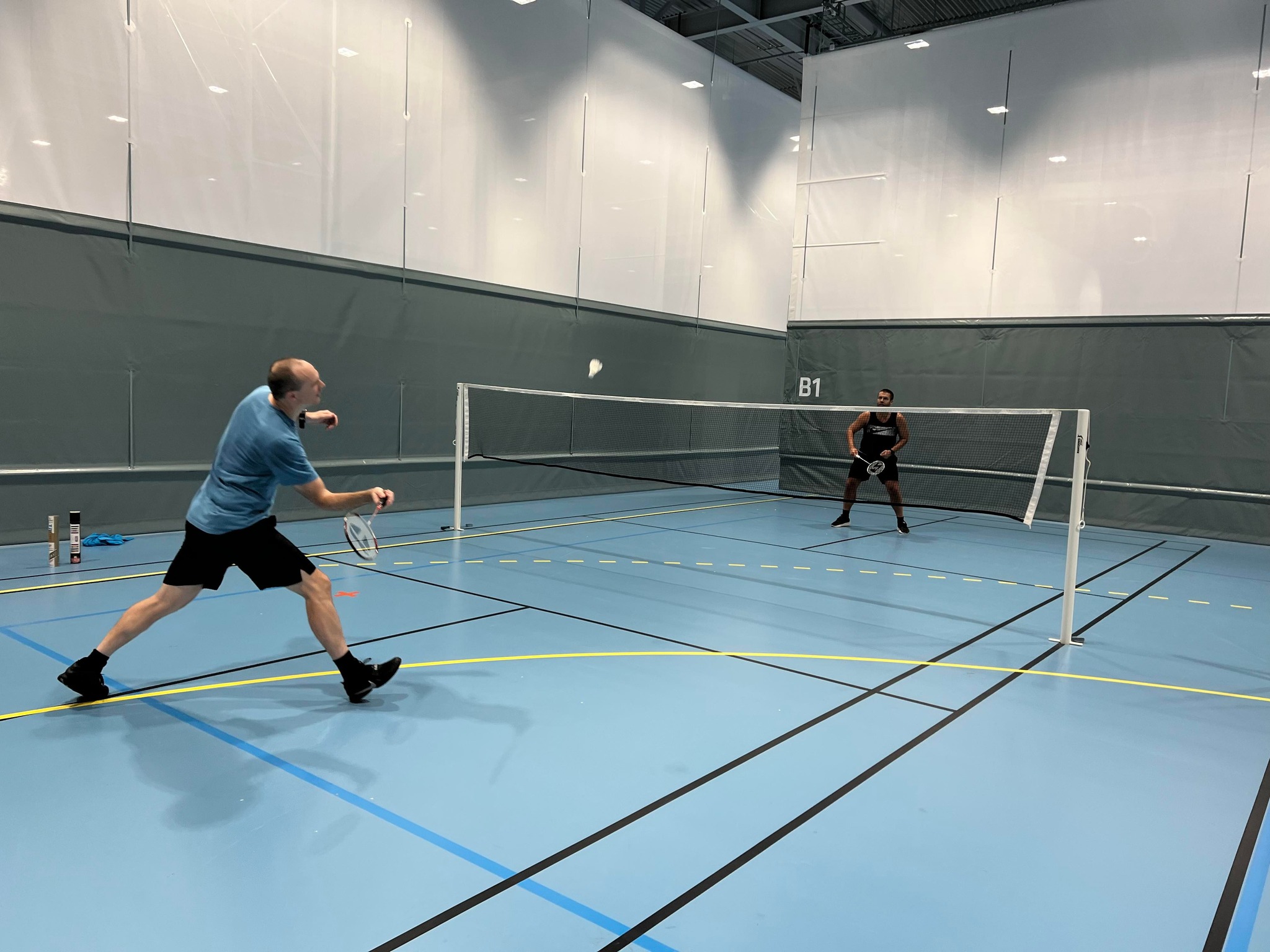 Two guys playing badminton